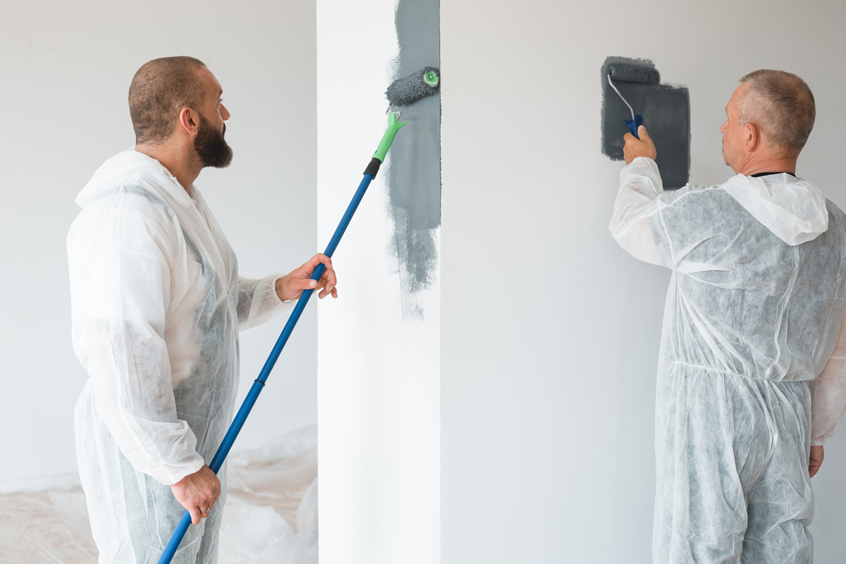 Two men painting the wall